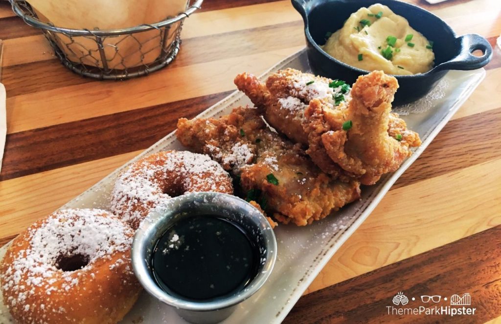 Walt Disney World Disney Springs Chef Art Smith's Homecomin Restaurant with Fried Chicken and Doughnuts and Mashed Potatoes Disney World breakfast and brunch. Keep reading to find out all you need to know about Walt Disney World.