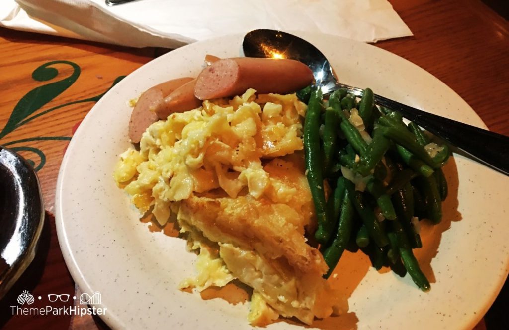 Walt Disney World Epcot Germany Pavilion Biergarten Restaurant Sausage green beans and mac and cheese. Keep reding for the full guide to the best buffet in Disney World.