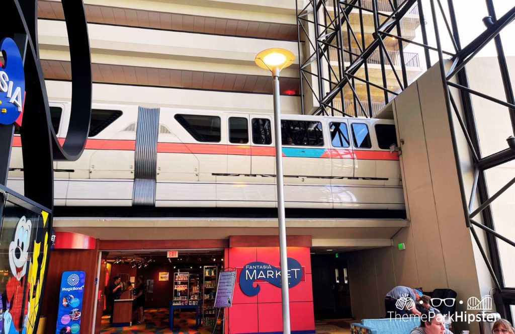 Disney's Contemporary Resort Monorail Passing By. Keep reading to get the ultimate guide on the best monorail resorts at Disney World.