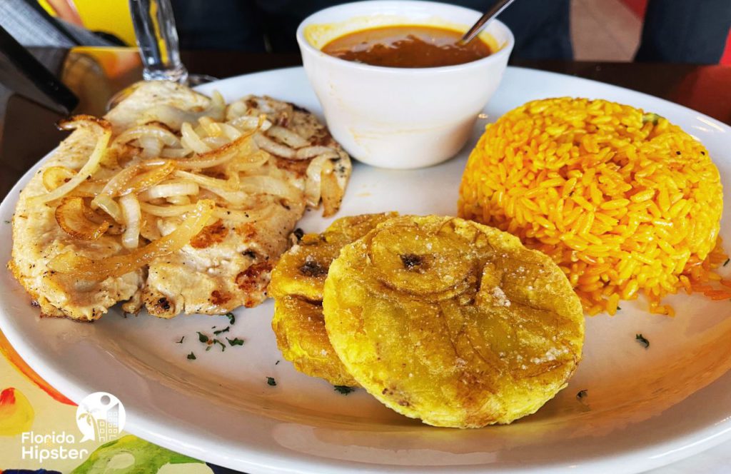 Downtown Mount Dora Florida Las Palmas Cuban Restaurant Grilled Chicken with Tostones, Yellow Rice, and Red Beans.